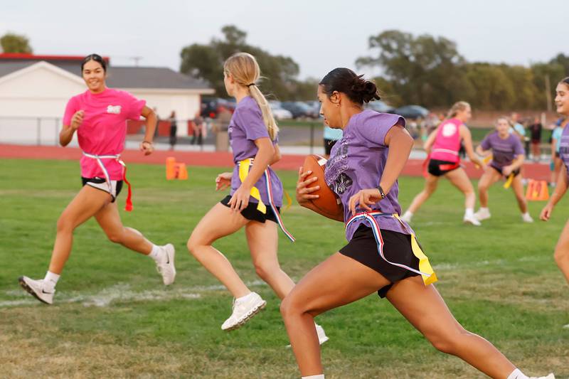 Wednesday evening the Erie High School football field brought EHS girls under the lights to compete in a fun homecoming tradition, Powder Puff football. Here, junior Ayden Grawe runs the ball up field in hopes of getting past her senior class opponent, who also happens to be her big sister Ava Grawe.