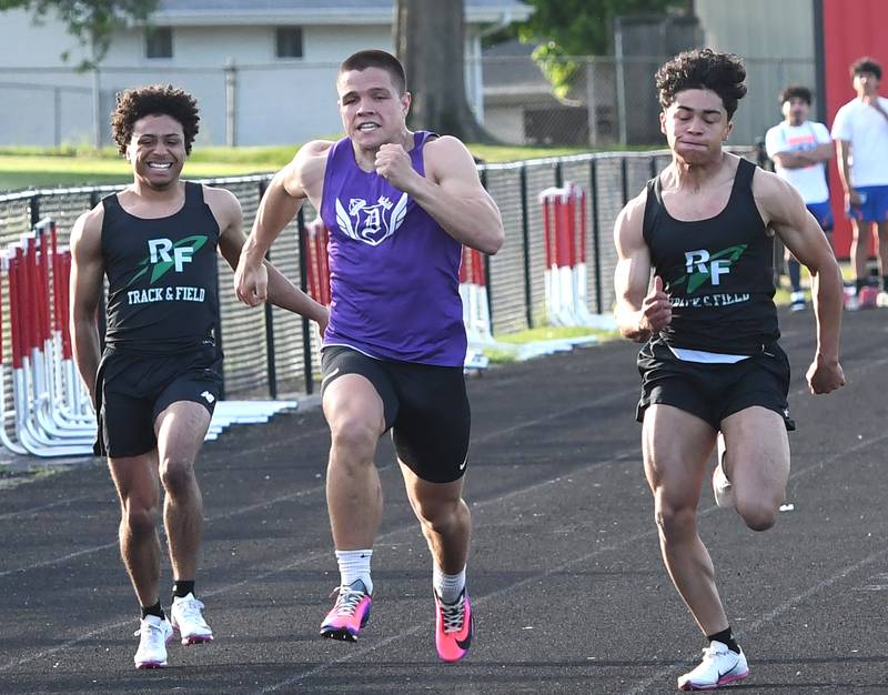 Rock Falls' Adan Oquendo (left) grabs his hamstring as he races Dixon's Owen Belzer (center) and Rock Falls Alexavier Oquendo in the finals of the 100 meters at the Big Northern Conference Meet at Stillman Valley on Thursday, May 14, 2026.