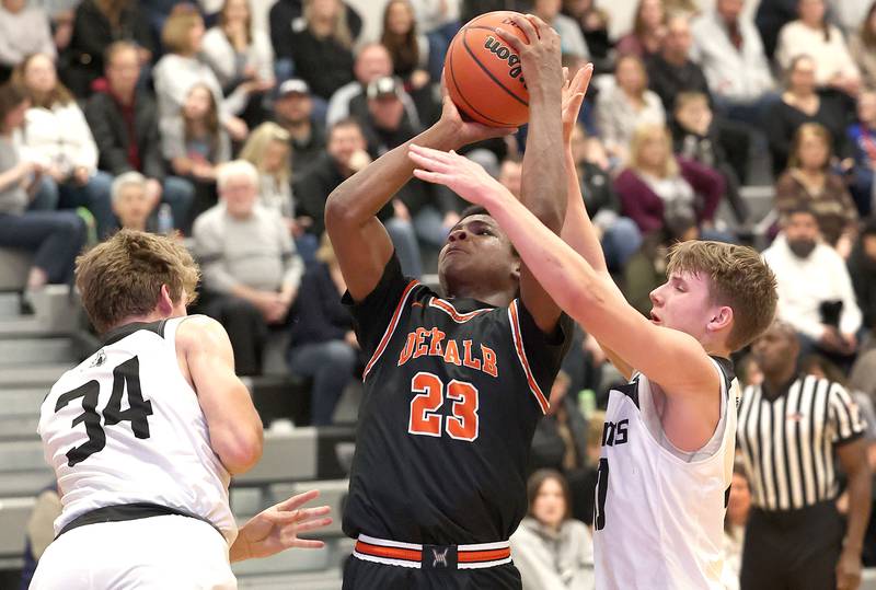 DeKalb's Davon Grant shoots a jumper between Kaneland's Parker Violett and Troyer Carlson during their game Tuesday, Jan. 24, 2023, at Kaneland High School.