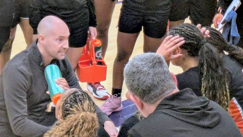 DeKalb coach Bradley Bjelk talks to his team during a first-quarter timeout during the Barbs' 46-31 win against Rochelle on Monday, Dec. 1, 2025, at Rochelle.
