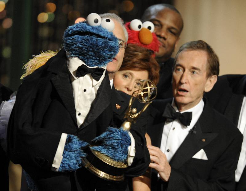 FILE - Bob McGrath, right, looks at the Cookie Monster as they accept the Lifetime Achievement Award for '"Sesame Street" at the Daytime Emmy Awards on Aug. 30, 2009, in Los Angeles. McGrath, an actor, musician and children’s author widely known for his portrayal of one of the first regular characters on the children’s show “Sesame Street” has died at the age of 90.  McGrath’s passing was confirmed by his family who posted on his Facebook page on Sunday, Dec. 4, 2022.   (AP Photo/Chris Pizzello, File)