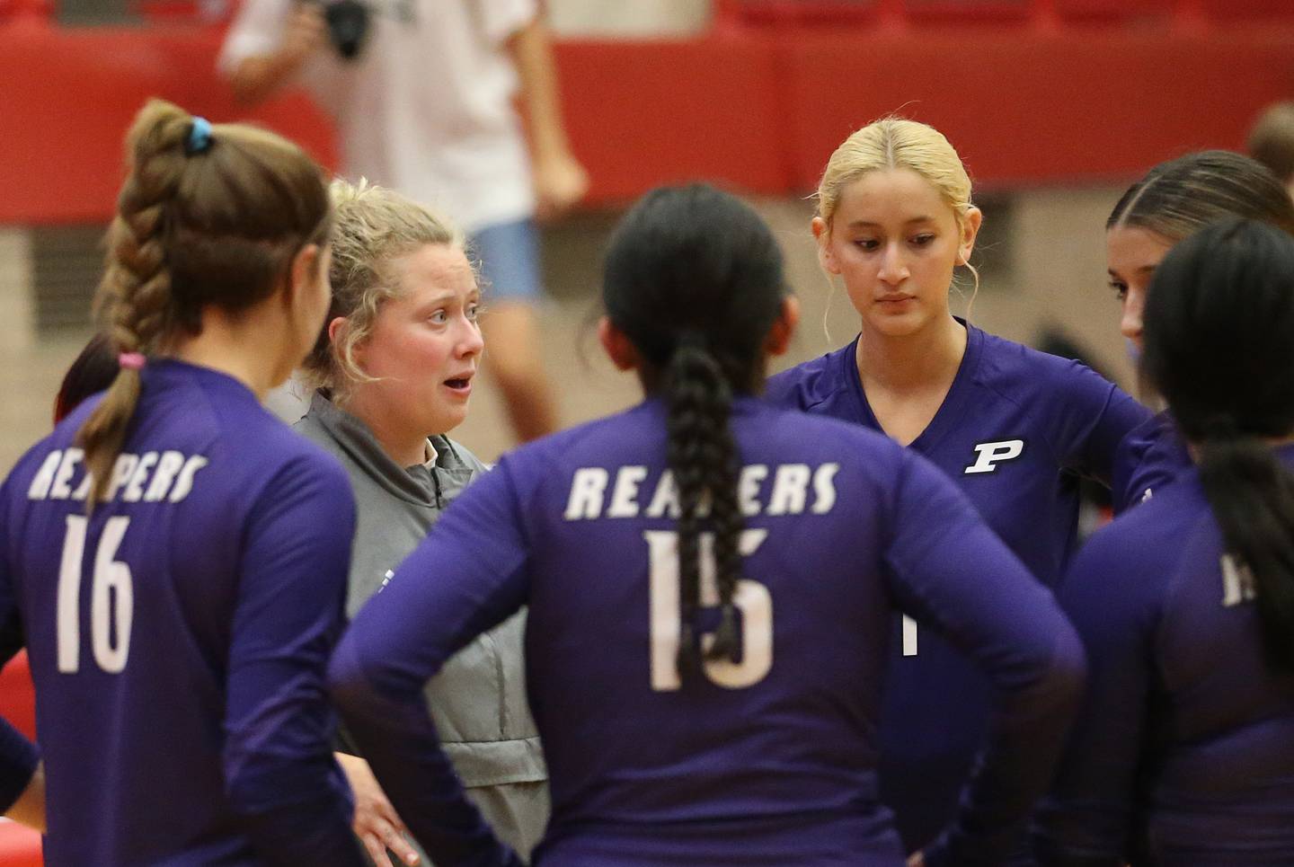 Plano head volleyball coach Brittany Hill huddles with her team while facing Ottawa on Thursday, Aug. 31, 2023 in Kingman Gym at Ottawa High School.