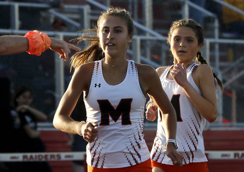 McHenry’s race the 3200 meter run Danielle Jensen and kyler Balzer during the Huntley IHSA Class 3A Girls Sectional Track and Field Meet on Wednesday, May 8, 2024, at Huntley High School.