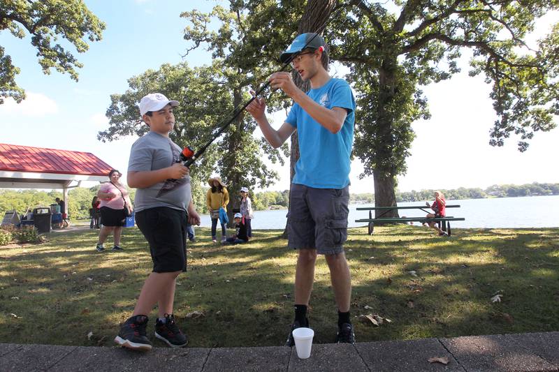 Leandro Martinez, 9, of Round Lake Beach learns how to fish from Nathan Bejnarowicz, of Lake Zurich with the Huebner Fishery Management Foundation during the Family Fishing Event at Lake Front Park on Saturday, September 9th in Round Lake Beach. The event was sponsored by the Round Lake Area Park District and the Huebner Fishery Management Foundation.
Photo by Candace H. Johnson for Shaw Local News Network