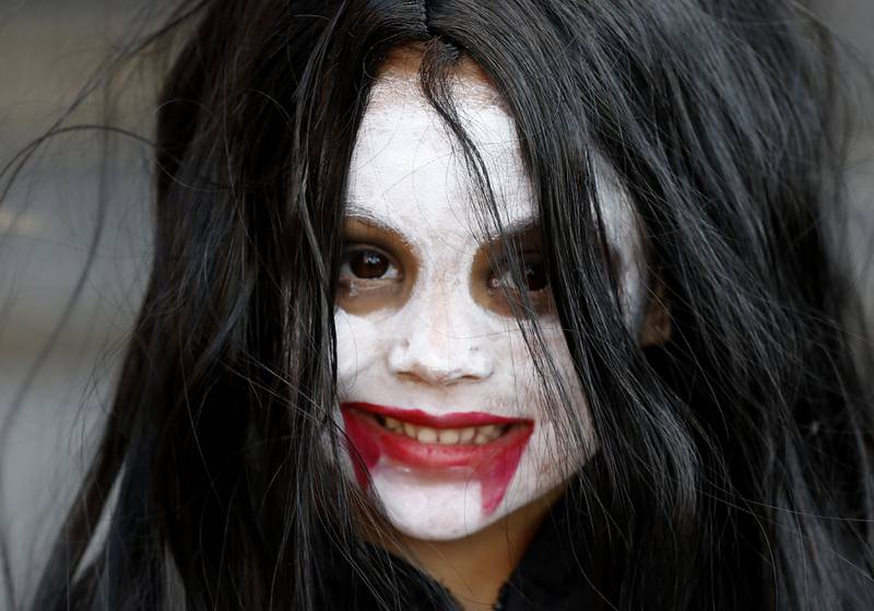 Helena Villaba, 4, trick or treats during Halloween on the Square on Thursday, Oct. 31, 2024, in Woodstock. The event featured trick and treating and a costume contest.