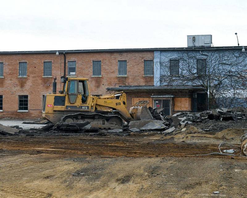 Construction crews began demolition of the former Mooney car dealership, along the east side of North Fourth Street between Oak and Locust streets Monday in DeKalb. Pappas Development LLC will begin construction of Agora Tower, a mixed-use residential and retail building, in the spring.