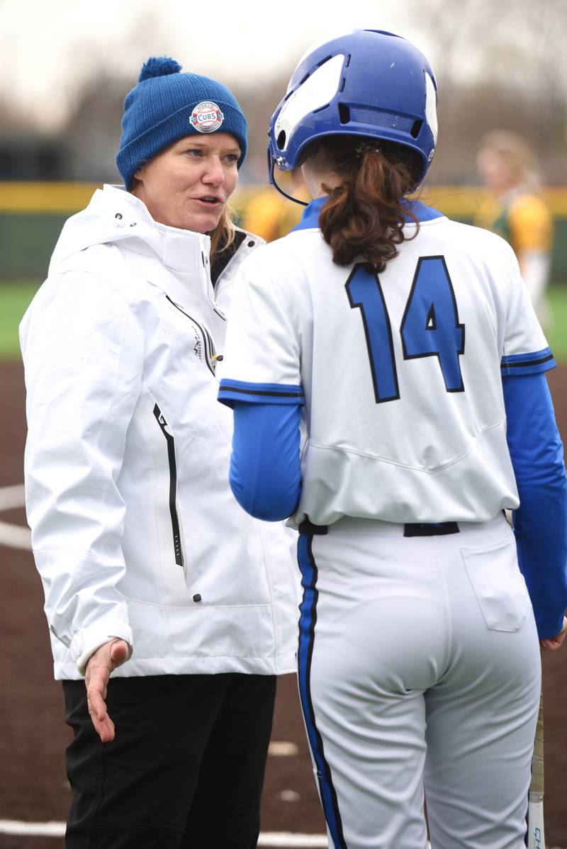 Peotone head softball coach Kim Pagliarulo, left, gives Caelan Farmer a pep talk during a break in the action in a game at Coal City Wednesday, April 9, 2025.