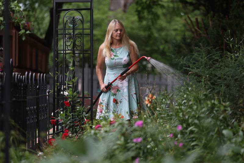 Daniell Gorman, of Joliet, waters her garden on Friday, Aug. 25, 2023.