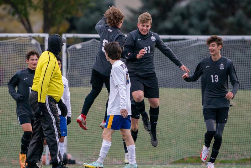 Wheaton Academy's William Clegg (21) celebrates with Scotty Murray (5) after scoring a goal against Johnsburg during a Wheaton Academy 1A sectional semifinal match at Wheaton Academy on Tuesday, Oct 18, 2022.