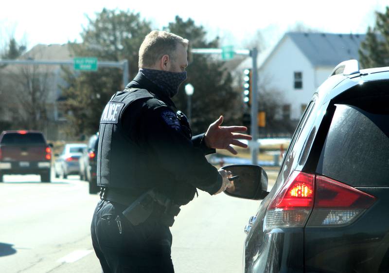 Oswego Police Officer Scott Hart talks to a motorist during a traffic stop last month.