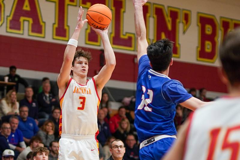 Batavia's Jax Abalos (3) shoots a three pointer against Marmion’s Samuel Dalmann (32) during a basketball game at Batavia High School on Wednesday, Nov. 27, 2024.