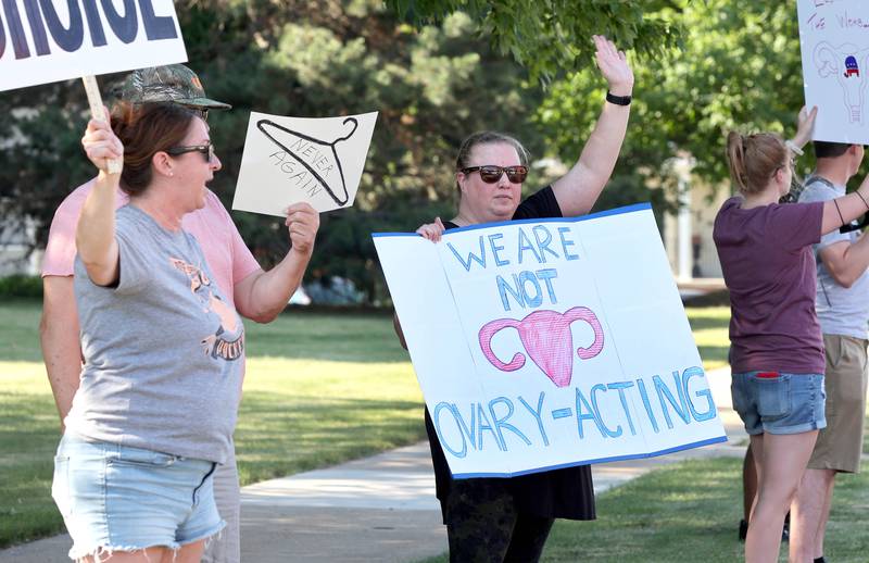 Protesters wave to passing cars Friday, June 24, 2022, during a rally for abortion rights in front of the DeKalb County Courthouse in Sycamore. The group was protesting Friday's decision by the Supreme Court to overturn Roe v. Wade, ending constitutional protections for abortion.