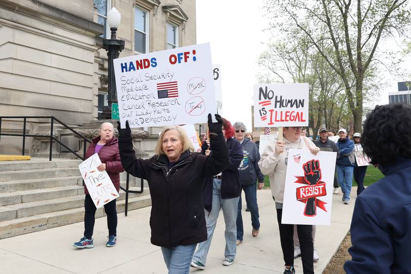 Laura Serra, of Manteno, carries a sign as she participates in rally chants during the Hands Off Rally at the Kankakee County Courthouse on Saturday, April 19, 2025.