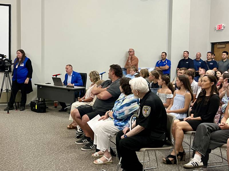 Dixon City Manager Danny Langloss (middle left) congratulates Dixon's new chief of police Ryan Bivins at Monday's city council meeting, June 2, 2025.