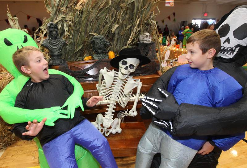 Caleb Schaffer, 8, of Antioch and his twin brother, Bryden, have fun sitting next to a skeleton on display while wearing their own costumes during Witchy Thrills & Chills at the Lindenhurst Park District Lippert Community Center on October 14th in Lindenhurst.
Photo by Candace H. Johnson for Shaw Local News Network