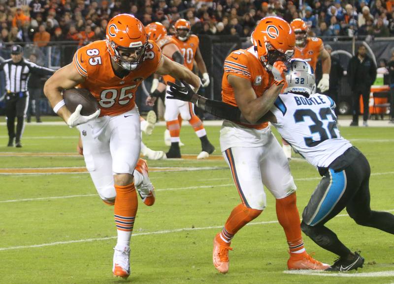 Chicago Bears tight end Cole Kmet runs the ball up field as teammate DJ Moore blocks Carolina Panthers cornerback Dicaprio Bottle on Thursday, Nov. 9, 2023 at Soldier Field.