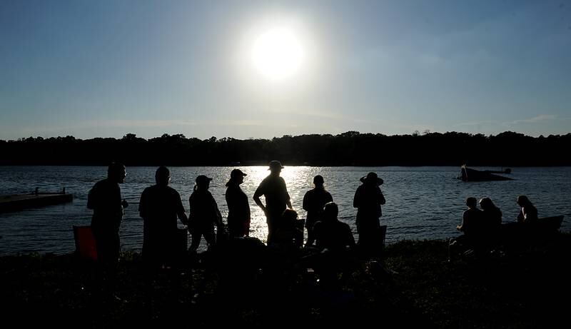 People watch the as skiers perform Tuesday, June 21, 2022, in the Wonder Lake Water Ski Show Team and Northern Illinois Special Recreation Association’s show on Wonder Lake. The performance was the end of the team’s learn to ski clinic. Members of ski team have constructed adaptive water ski equipment, which has proven year after year to be successful in allowing every participant to be able to water ski.