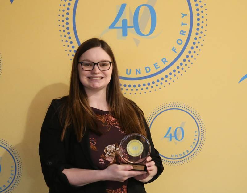 Emily Hardee poses for a photo with her award during the 40 Under Forty awards banquet on Thursday, March 21, 2024 at Westclox in Peru.