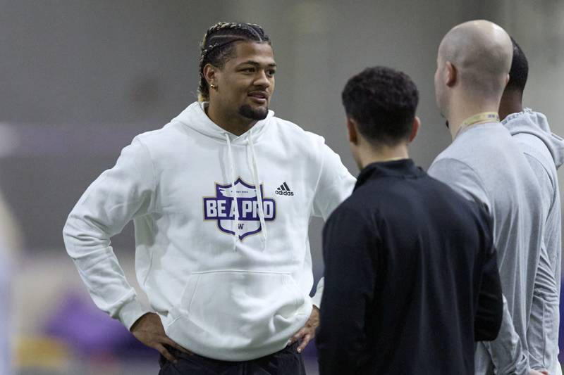 Washington wide receiver Rome Odunze talks while standing on the field during Washington's NFL Pro Day, Thursday, March 28, 2024, in Seattle. Odunze did not participate in the day. (AP Photo/John Froschauer)