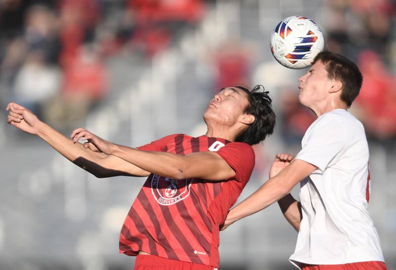 Naperville Central’s Nathan Kwon and Hinsdale Central’s Oliver Pohlenz jump for the ball in the Class 3A East Aurora supersectional boys soccer game on Tuesday, November 1, 2022.