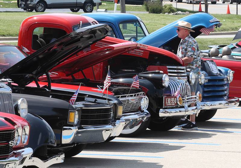 Visitors check out some of the cars Saturday, June 14, 2025, at the Flag Day Car Show in the Hy-Vee parking lot in Sycamore.