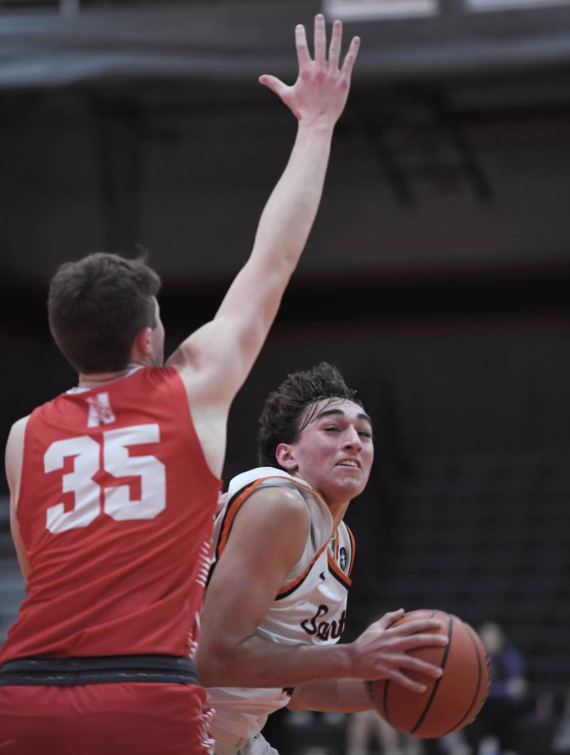 St. Charles East’s Eddie Herrera competes against Naperville Central’s Jack First in a boys basketball game in St. Charles on Wednesday, January 25, 2023.