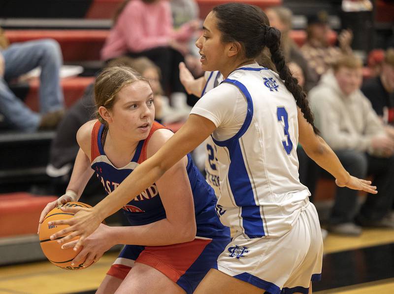 Eastland’s Izzy Ames looks to pass while being defended by Newman’s Paizlee Williams Tuesday, Feb. 18, 2025, during the Class 1A girls basketball regional at Forreston.