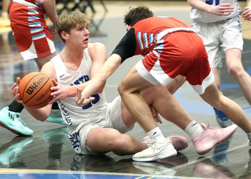 Burlington Central's Jacob Johnson tries to keep the ball away from Marian Central's Andrew Dovidio Monday, Jan. 15, 2023, during their game in the Burlington Central Martin Luther King Jr. boys basketball tournament.