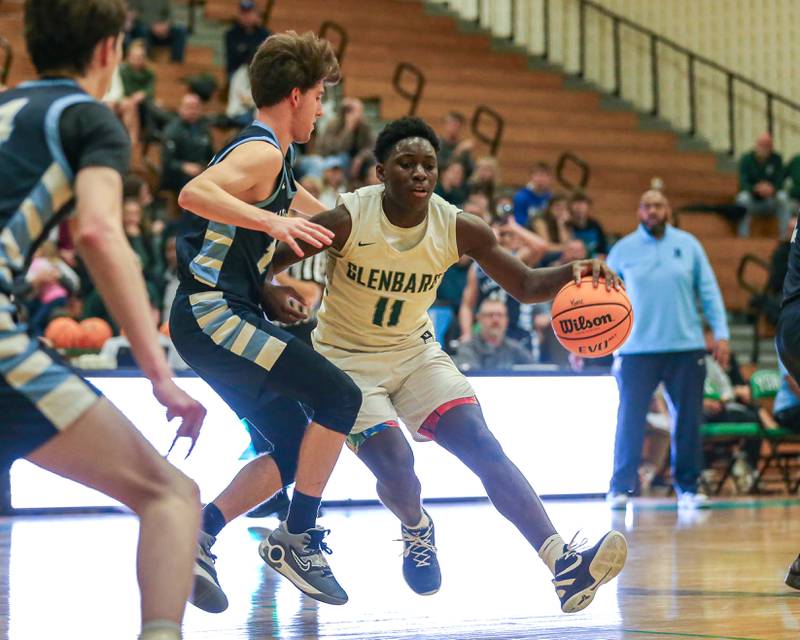 Glenbard West's Teyion Oriental (11) makes a move around the defense during their Jack Tosh Holiday Classic basketball tournament game between Nazareth vs Glenbard West. Thursday Dec 26, 2024 in Elmhurst.