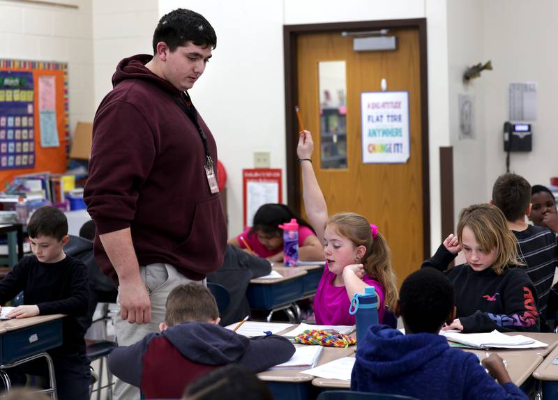 Drew Hoth, former Northern Illinois University football player and current student teacher in District 428, checks in with a student Thursday, March 20, 2025, at Jefferson Elementary School in DeKalb.