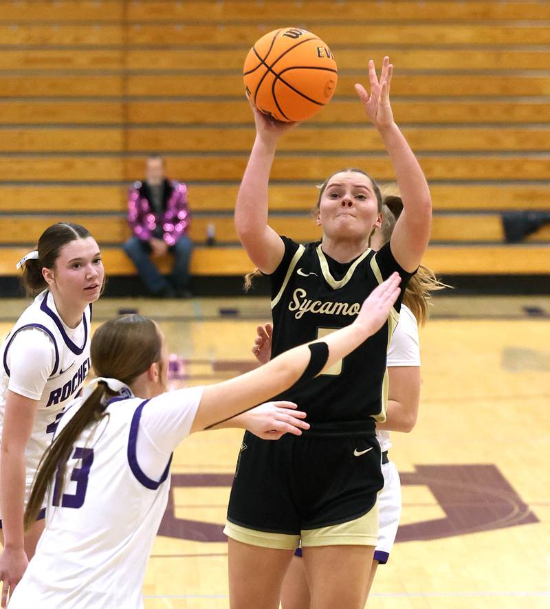 Sycamore's Grace Amptmann shoots between three Rochelle defenders Friday, Dec. 5, 2025, during their game at Rochelle High School.
