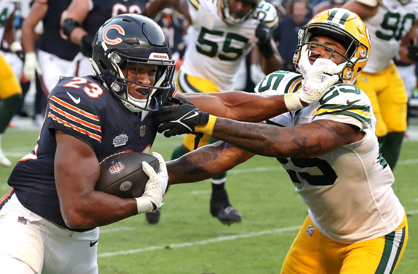 Chicago Bears running back Roschon Johnson fends off Green Bay Packers cornerback Keisean Nixon during their game Sunday, Sept. 10, 2023, at Soldier Field in Chicago.