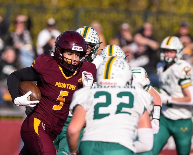 Montini Catholic's Nico Castaldo (5) gains some yards before being brought down by Coal City defenders during the 4A quarterfinals game on Saturday Nov. 15, 2025, held at Montini Catholic High School.