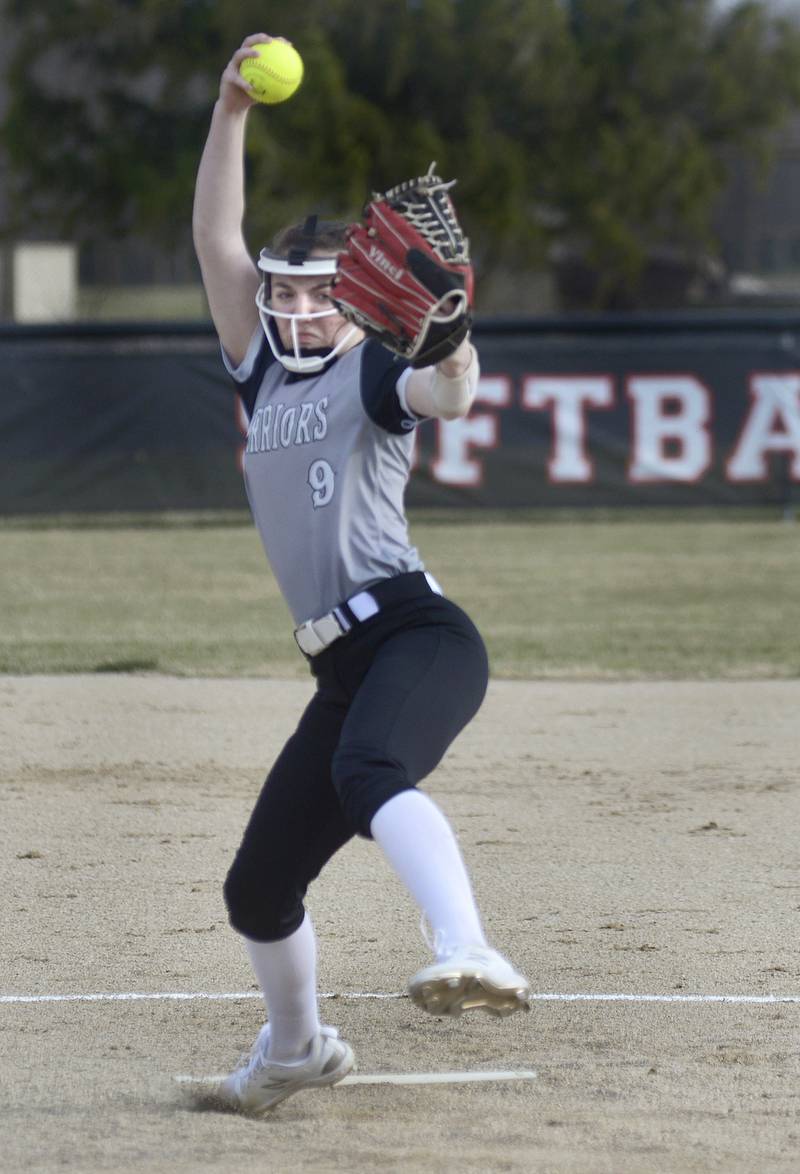 Woodland/Flanagan-Cornell starting pitcher Shae Simons (9) winds up and fires home Tuesday, March 12, 2024, during her season-opening perfect game against Hall in rural Streator.