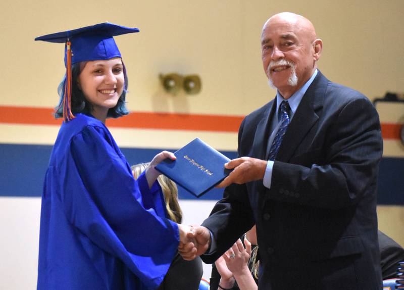 Bailee Davidson receives her diploma from Grandpa Bob Davidson Saturday, May 17, 2025, during Genoa-Kingston High School graduation at the school.