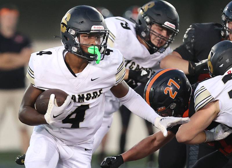 Sycamore's Tyler Curtis gets around DeKalb's Daniel Roman-Johnson during the First National Challenge Friday, Aug. 26, 2022, in Huskie Stadium at Northern Illinois University in DeKalb.