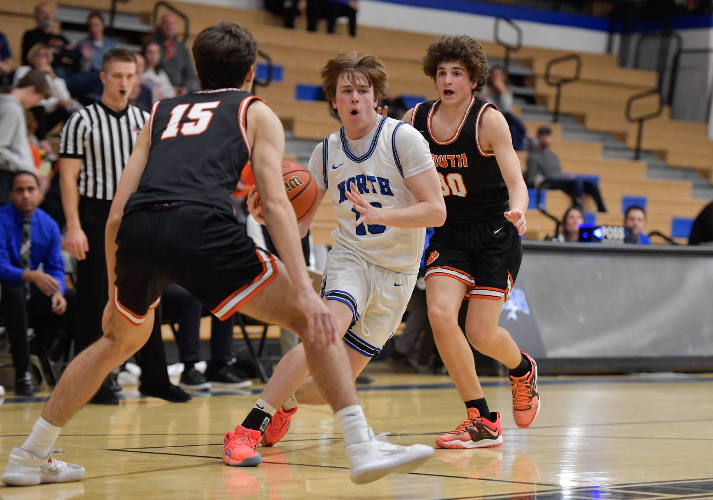St. Charles North's Daniel Connolly (10) drives between Wheaton Warrenville South Nick Brooks (15) and Luca Carbonaro (30) during a game on Friday, December 2, 2022.