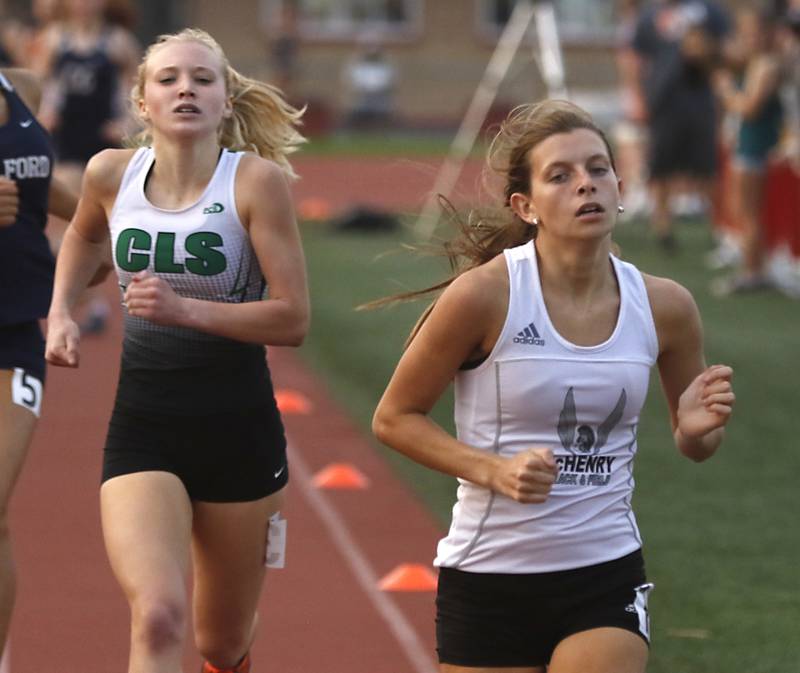Crystal Lake South’s Abby Machesky chases McHenry’s Alyssa Moore as they race to the finish line in the 800 meters during the IHSA Class 3A Huntley Girls Track Sectional Wednesday, May 11, 2022, at Huntley High School.