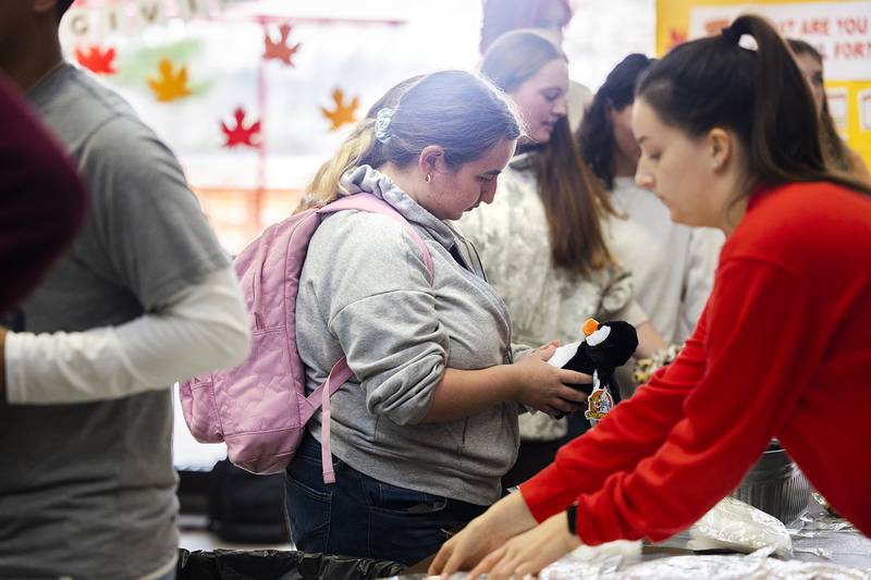 Morgan Pratt of Sterling checks out her stuffed penguin Wednesday, Nov. 13, 2024, at Sauk Valley Community College. SVCC’s student government held a Friendsgiving event where students could choose and stuff an animal and make a friendship bracelet with supplies provided by the school.