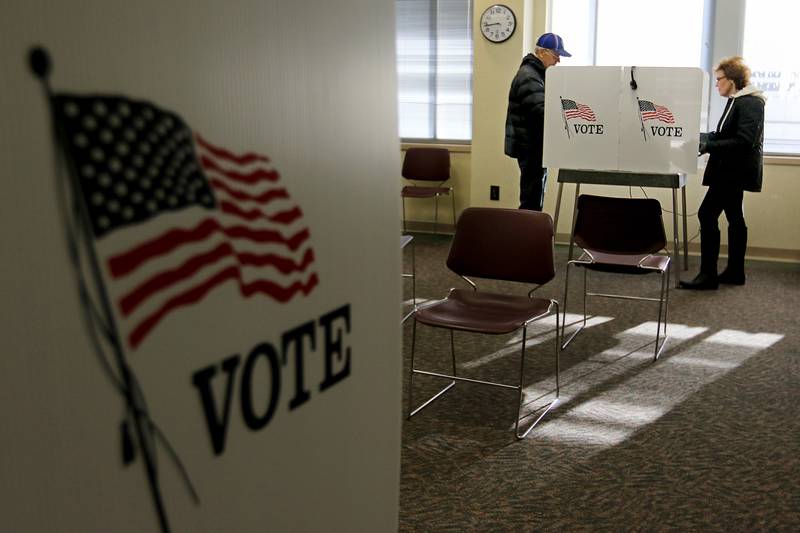 Phil and wife Judy McBride of Woodstock cast their votes in the election at the McHenry County Administration Building on Tuesday, March 17, 2020 in Woodstock.  Voter turnout was much lower than usual, due to an increase in early and absentee voting as well as fear over spread of the coronavirus.