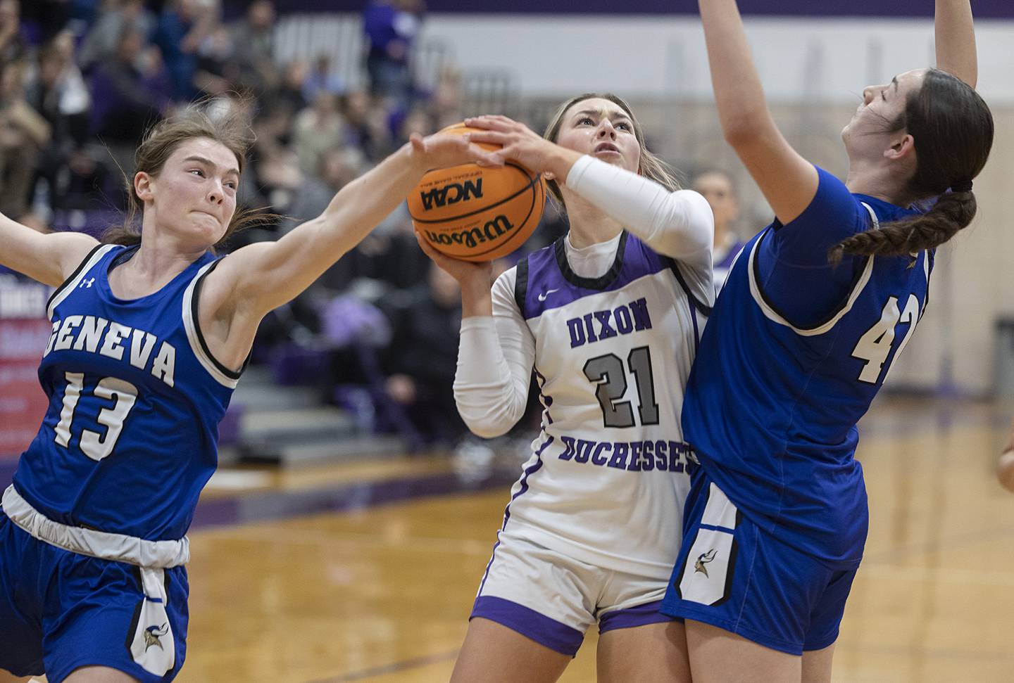 Dixon’s Reese Dambman works against Geneva’s Linnea Popp (left) and Adelyn Estabrook Thursday, Feb. 19, 2026, in the Class 3A girls basketball regional title game.