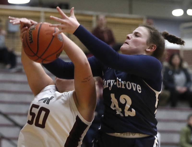 Prairie Ridge's Grace Wolf and Cary-Grove's Emily Larry battle for a rebound during a Fox Valley Conference girls basketball game Wednesday, Jan. 17, 2024, at Prairie Ridge High School.