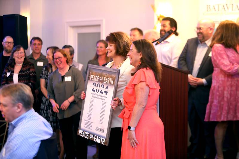 Britta McKenna holds the award for the Community Impact Award for the Peace Bridge project along with other organizers and sponsors of the project during the Batavia Chamber of Commerce’s Inspire Celebration Awards Ceremony on Thursday, April 24, 2025 at Revelry 675 in Batavia.