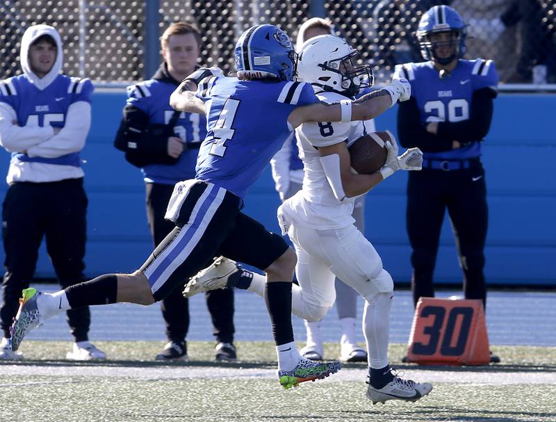 Cary-Grove's Andrew Prio is tackled by Lake Zurich's Nolan Siko after a long run during a IHSA Class 6A semifinal playoff football game on Saturday, Nov. 18, 2023, at Lake Zurich High School.