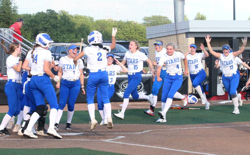 Members of the St. Charles North softball team run to home plate after teammate Ginger Ritter smaked a home run during the Class 4A championship game on Saturday, June 8, 2024 at the Louisville Slugger Sports Complex in Peoria.