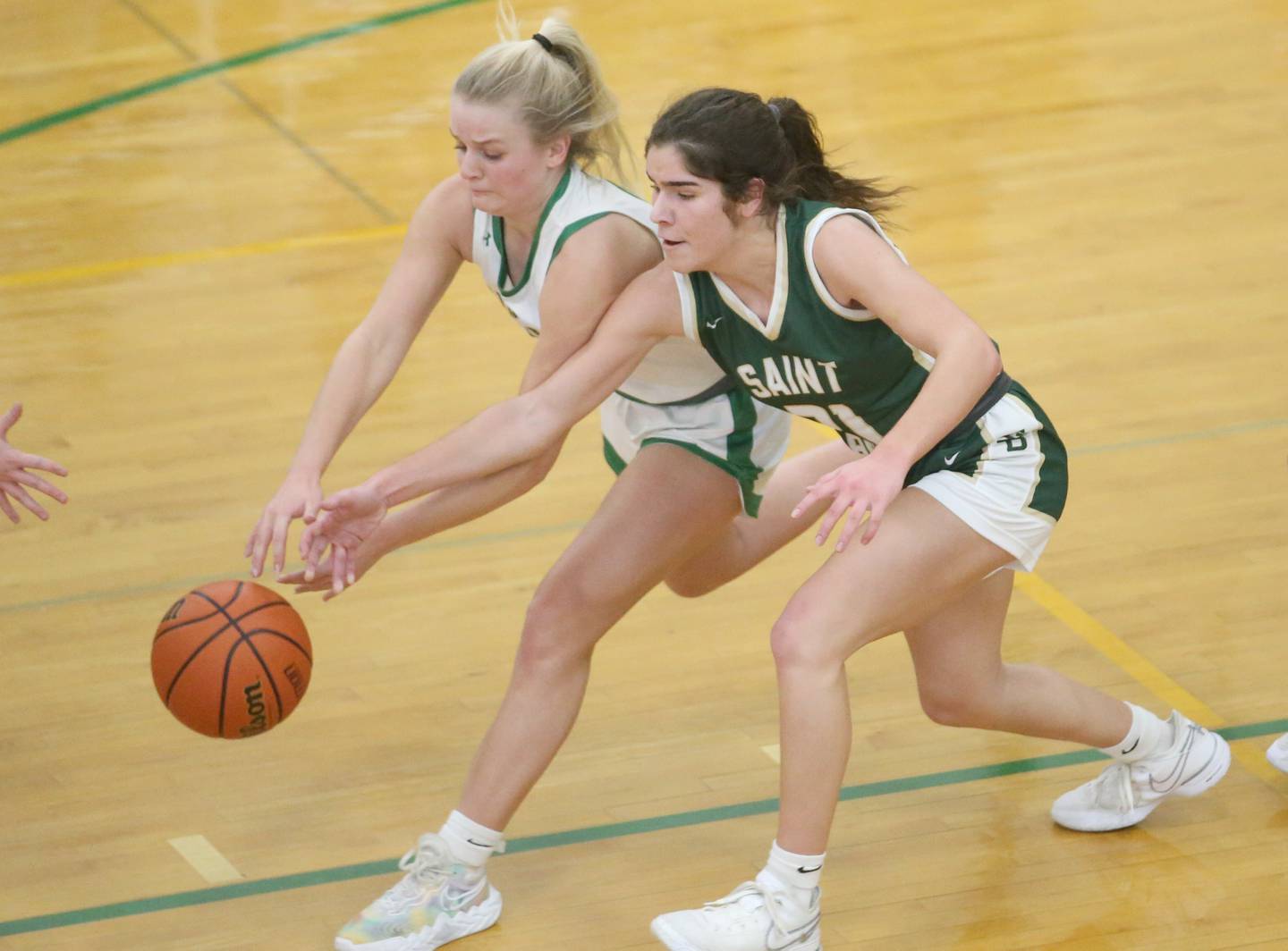 Seneca's Lainie Olson and St. Bede's Lily Bosnich chase after a loose ball in a game last season at Seneca High School.