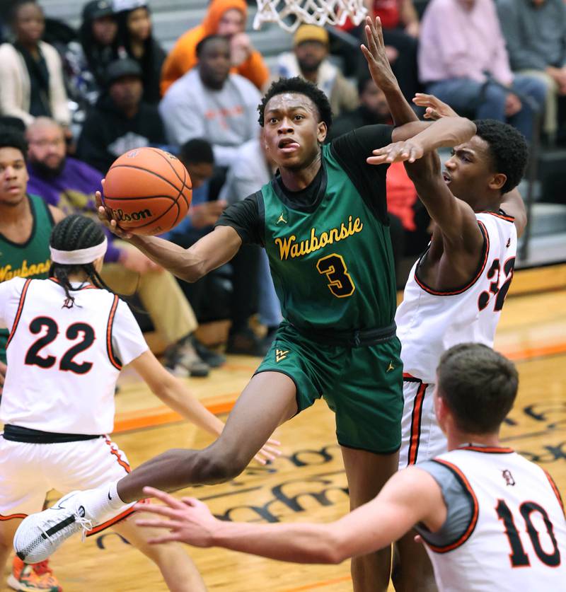 Waubonsie Valley's Tre Blissett gets to the basket in front of DeKalb’s Justin O’Neal during their game Friday, Dec. 15, 2023, at DeKalb High School.