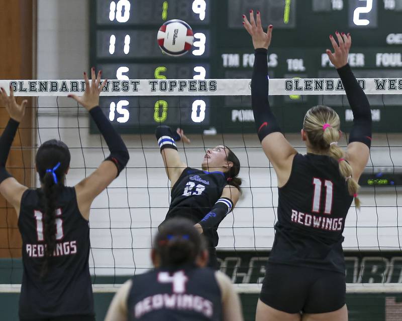 St Charles North's Haley Burgdorf (23) goes for a kill during Class 4A Glenbard West Sectional final volleyball match between St Charles North at Benet. Nov 6, 2025 in Glen Ellyn.