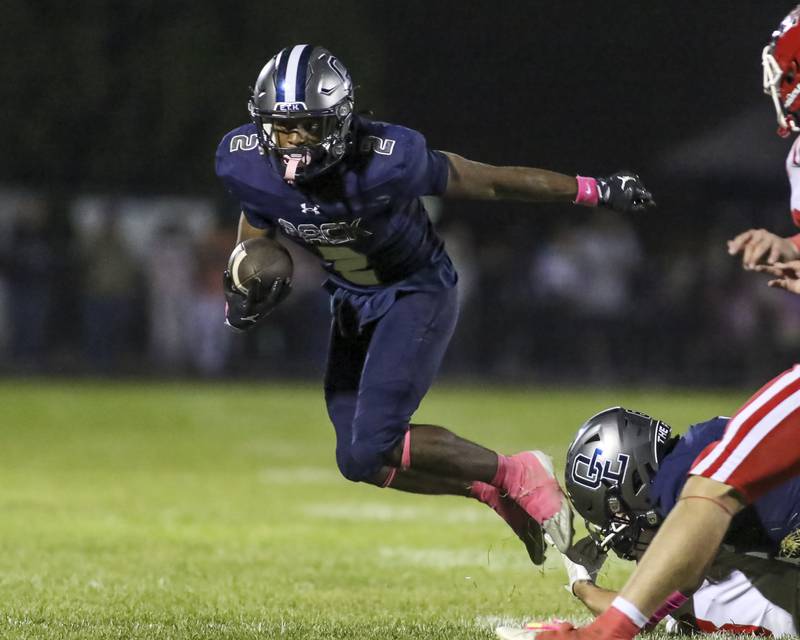 Oswego East's Jasiah Watson (2) looks for running room during football game between Yorkville at Oswego East Friday, Oct 10, 2025 in Oswego.
