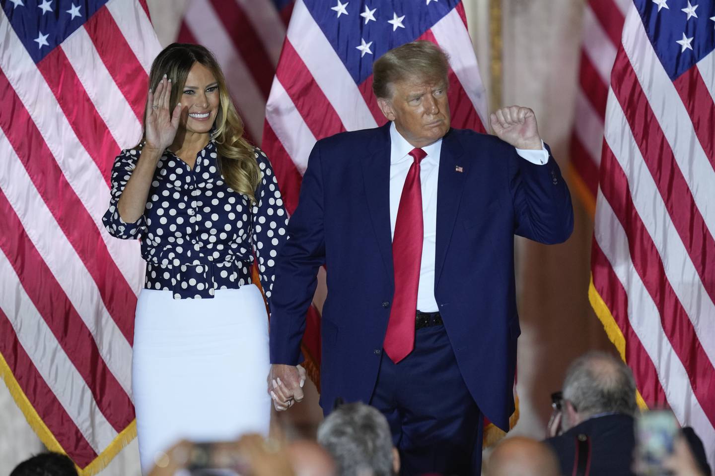 Former President Donald Trump stands on stage with former first lady Melania Trump after announcing a third run for president at Mar-a-Lago in Palm Beach, Fla., Tuesday, Nov. 15, 2022. (AP Photo/Rebecca Blackwell)